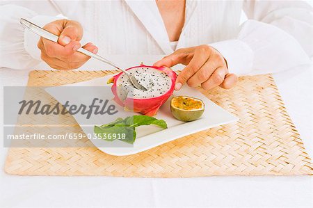 Woman eating pitahaya