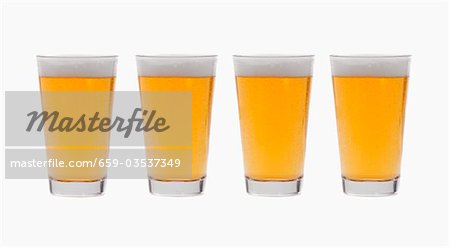 Four glasses of lager side by side Four glasses of lager side by side