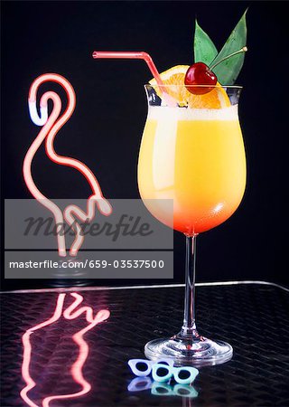 Cocktail in front of neon flamingo light