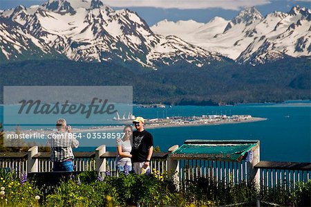 Tourists take pictures of the view of the Homer Spit, Kachemak Bay and the Kenai Mountains from the Baycrest Overlook on the Sterling Highway, Alaska