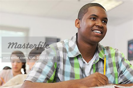 Male high school student working in classroom