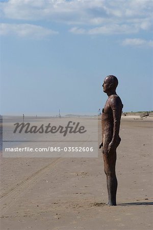 Some of the 100 iron men at Crosby Beach as part of Anthony Gormley's Another Place, Liverpool, Merseyside, England