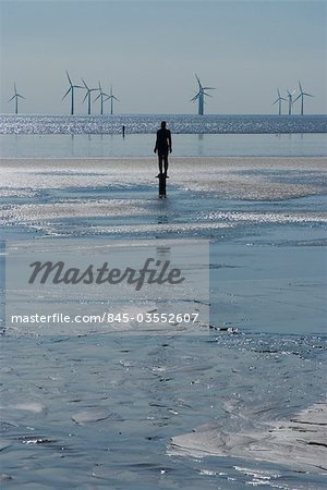 Un des hommes 100 fer à Crosby Beach, dans le cadre d'un autre endroit de Anthony Gormley, générateurs de vent derrière, Liverpool, Merseyside, Angleterre