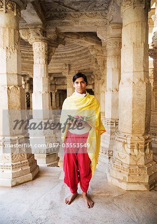 Teenage boy holding religious offering in a temple, Adinath Temple, Jain Temple, Ranakpur, Pali District, Udaipur, Rajasthan, India