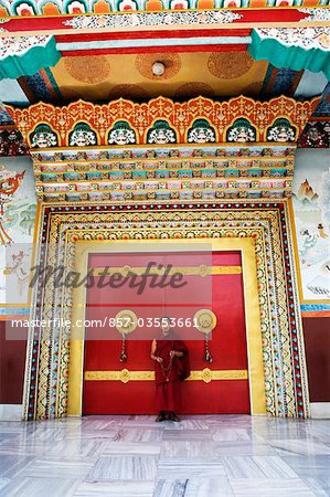 Monk standing in front of a door, Bodhgaya, Gaya, Bihar, India