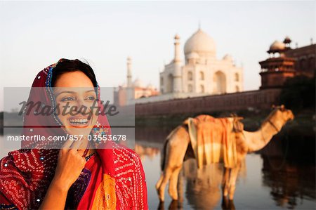 Woman smiling with mausoleum in the background, Taj Mahal, Agra, Uttar Pradesh, India