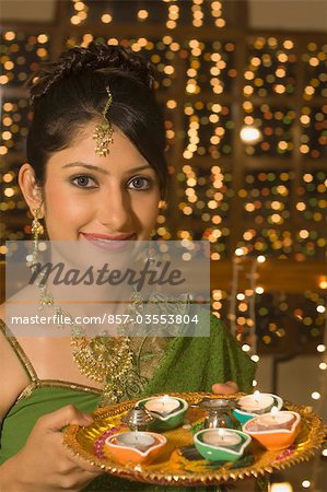Woman holding a traditional Diwali thali