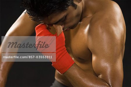Close-up of a male boxer looking depressed