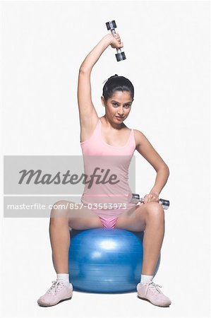 Young woman exercising on a fitness ball