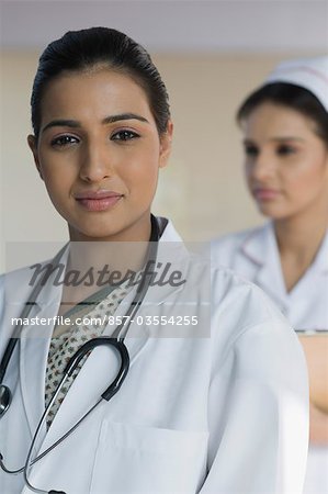 Portrait of a female doctor with a female nurse in the background, Gurgaon, Haryana, India