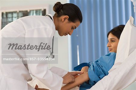 Female doctor injecting medicine to a patient, Gurgaon, Haryana, India