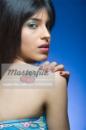 Portrait of a woman with tattoo on her shoulder