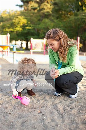 Mother and Daughter in Sandbox in Green Lake Park in Autumn, Seattle, Washington, USA