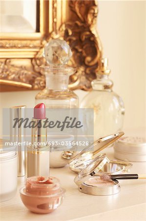 Table With lipstick and other Cosmetics and Wall Mirror