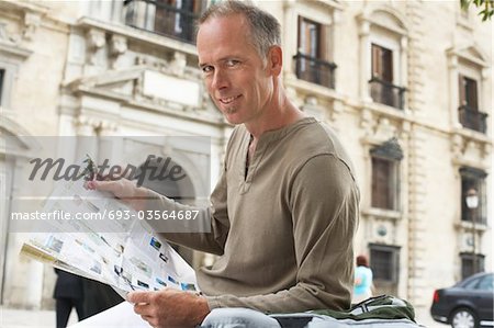 Man with Guidebook in Street