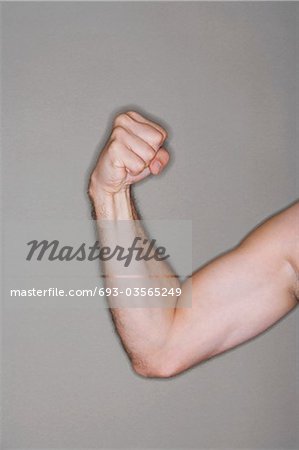 Man flexing biceps, close-up on arm