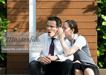 Surprised man hears office gossip