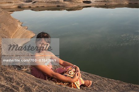 Mädchen sitzen am Teich bei SamPanBok, Provinz Ubon Ratchathani, Thailand