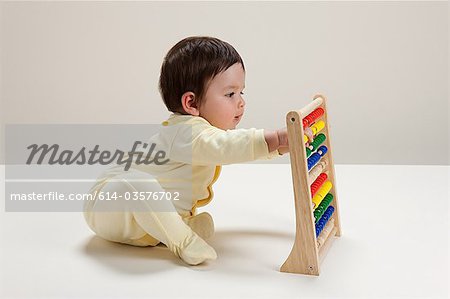 Baby boy playing with abacus