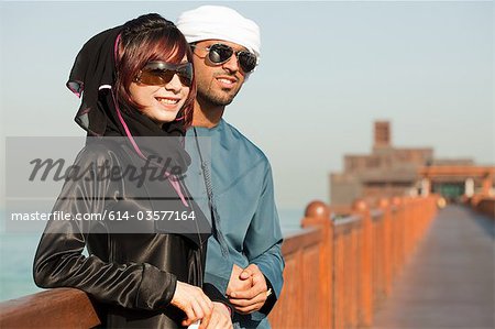 Middle Eastern people and fence, outdoors