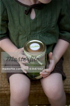 Young Girl Holding Jar of Pickles