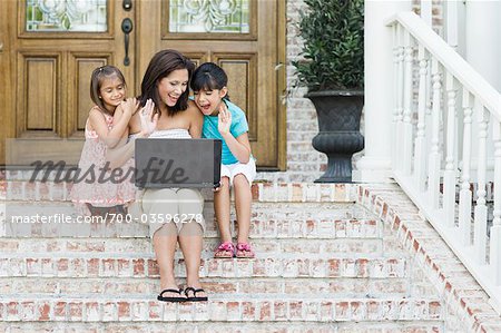 Mother and Daughters Using Laptop Computer
