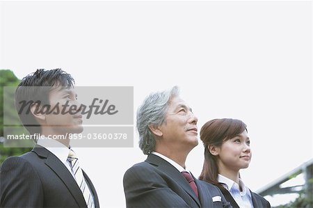 Businessmen And Businesswoman Looking Up