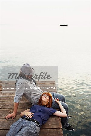 Couple resting on jetty