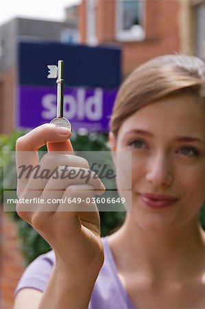 Woman first time buyer holds up door key