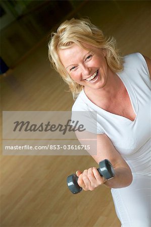 Reife Frau Gewichtheben in Turnhalle