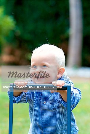 Toddler walking with walking aid