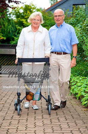 Senior couple with walking frame making purchases