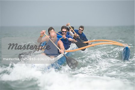 Outrigger canoeing team on water