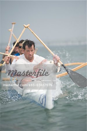 Outrigger canoeing team on water