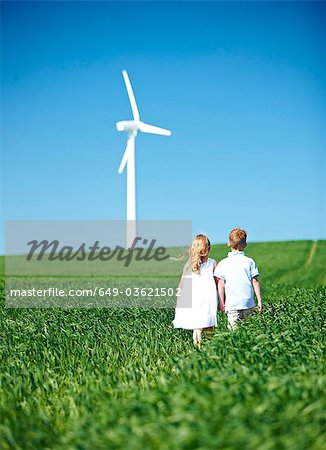 Boy and girl lookng at wind turbine