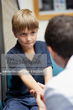 Doctor examining young boy