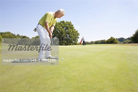 Caddy pointing at a hole on golf course