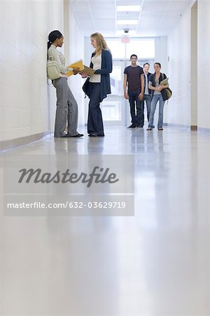 High school students talking in school corridor