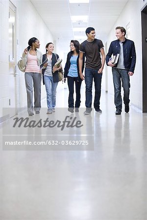 High school students walking down school corridor