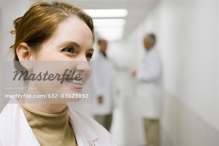 Healthcare worker smiling, looking away, portrait