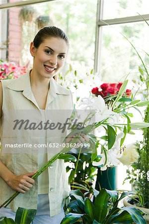 Young woman holding lilies, portrait