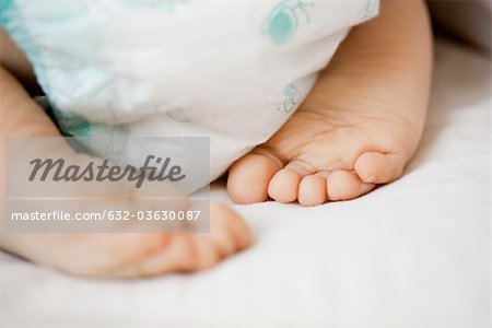 Baby's diaper and bare feet, close-up