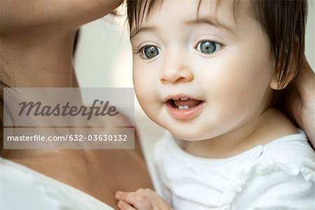 Baby girl in mother's arms, portrait