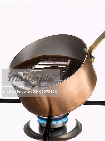 Melting dark chocolate in a copper saucepan