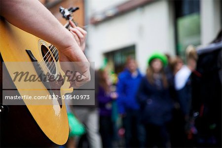 Dublin, Ireland; A Musician Plays His Guitar In The Street