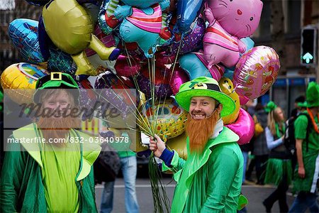 Dublin, Ireland; Men Dressed As Leprechauns Holding Balloons On The Street On Saint Patrick's Day