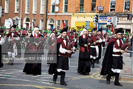 Dublin, Ireland; A Band Of Bagpipers In A Parade On O'connell Street