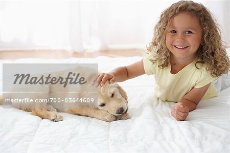 Little Girl With Goldendoodle Puppy
