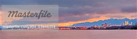Panoramic skyline view of the sun rising over Anchorage, Cook Inlet and Knik Arm, Southcentral Alaska, Fall
