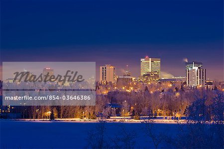 Skyline view of downtown Anchorage and Westchester Lagoon at twilight, Southcentral Alaska, Winter